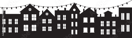 Black silhouette of townhouses with string lights buildings