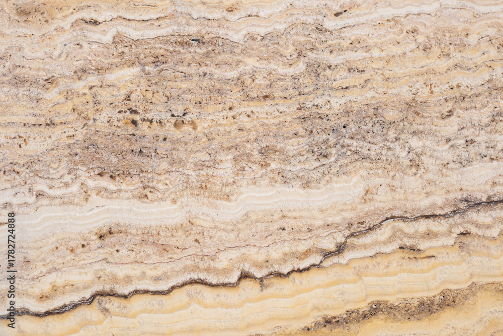 Naklejka premium Textured marble surface with natural swirls and earthy tones for backgrounds