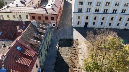 Kaunas, Lithuania – October 17, 2024: Aerial view of Kaunas Town Hall Square during renovation with paving replacement, construction workers and equipment visible in the old town public space.