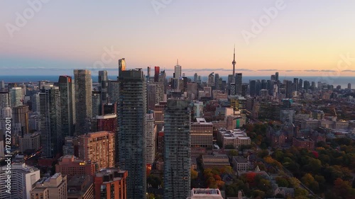 Spectacular panoramic evening drone view of modern Downtown skyscrapers and Lake Ontario in Toronto, Ontario, Canada.