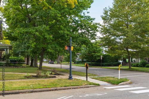 An intersection in a residential area in Warren, Pennsylvania, USA on a sunny summer day