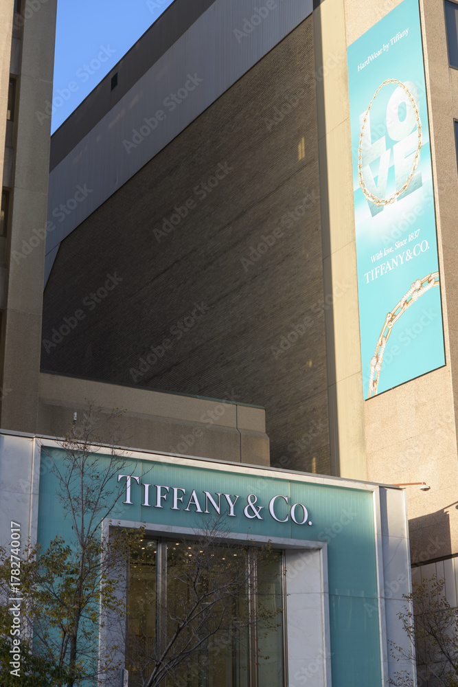 Obraz premium exterior wall and long hanging banner and sign over entrance to Tiffany & Co, a jewelry store, located at 150 Bloor St W (inside 89 Avenue Yorkville), Toronto