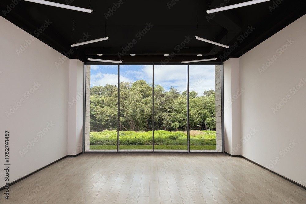 Fototapeta premium Floor-to-ceiling window with garden view in empty spacious room. Interior design