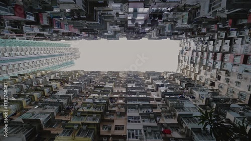 Famous Monster building with small balconies on facade in dwelling block under gloomy sky. Old condominium complex popular among tourists in Asian city. Architecture
