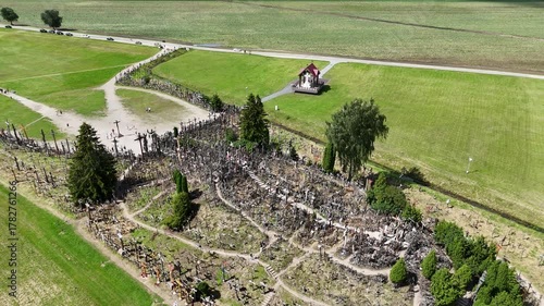 Hill of Crosses, Siauliai, Lithuania — August 1, 2025: Panoramic aerial footage captured by drone. The scene shows thousands of wooden and metal crosses, walking paths and the surrounding countryside 