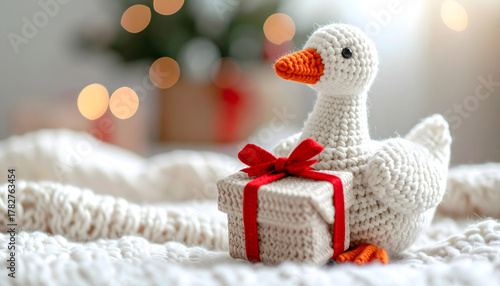 white knitted goose with gift with red bow