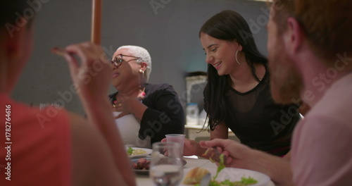 Murais de parede Group of friends laughing and enjoying a cheerful moment together at an outdoor