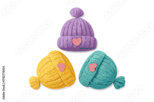 Three colorful knitted winter hats with heart patches isolated on a white background