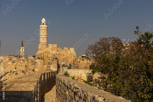 jerusalem, Israel, 9 October 2025, View along the narrow, cobblestone walkway on top of the old city walls, looking towards the towering citadel (tower of david) and a nearby church spire.