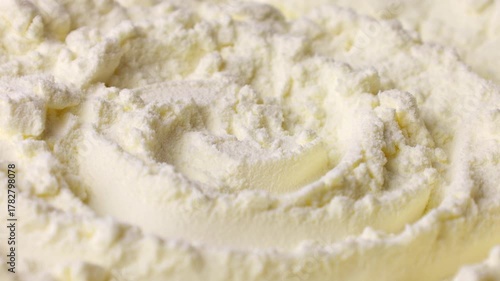 White powdered milk or baby formula texture circle rotation close up
