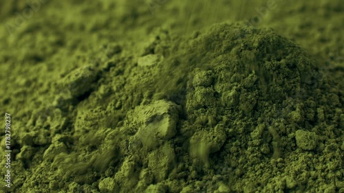 Matcha green tea powder falling down close up. Moringa, Spirulina, chlorella superfoods