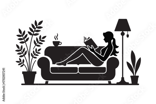 Silhouette of a woman reading a book on a couch with plants and a lamp