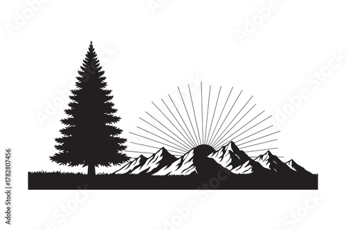 Silhouette of a lone pine tree and mountains at sunrise