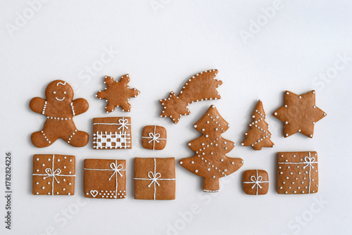 Decorated Christmas gingerbread cookies of various shapes, white background, copy space for text