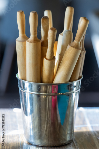 Russia. Saint Petersburg. Wooden rolling pins in a metal bucket.