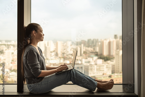 A young woman works on her laptop while sitting by a large window overlooking the city. Represents remote work, freelance lifestyle, online business, and productivity
Free Download A young woman works on her laptop while sitting by a large window overlooking the city. Represents remote work, freelance lifestyle, online business, and productivity
- GFXLoad