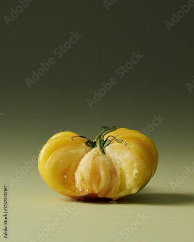 Yellow Heirloom Torn Tomatoes Painterly Still Life on Green Seamless background. Film grain