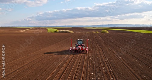Tractor seeding field preparing soil for planting crops
