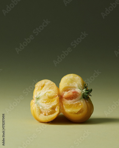 Sexy Yellow Heirloom Torn Tomatoes Painterly Still Life on Green Seamless background. Film grain