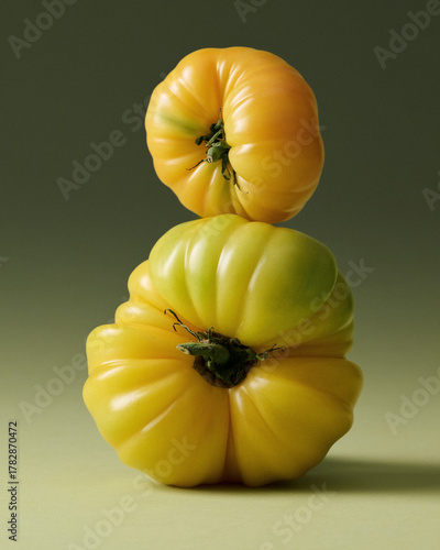 Yellow Heirloom Tomatoes Stacked Painterly Still Life on Green Seamless background. Film grain