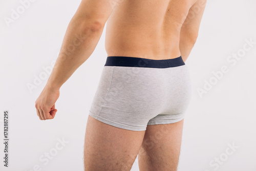 body parts: male ass in close-up in gray boxers on a white isolated background. male health: prevention of prostatitis and hemorrhoids