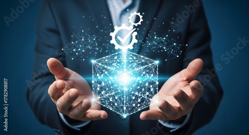 Businessman holding a digital cube representing solutions, data, and technology with a gears and