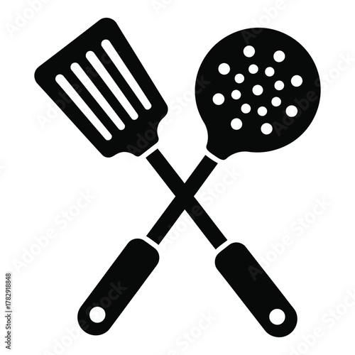 Crossed black cooking spatula and slotted spoon silhouette kitchenware illustration