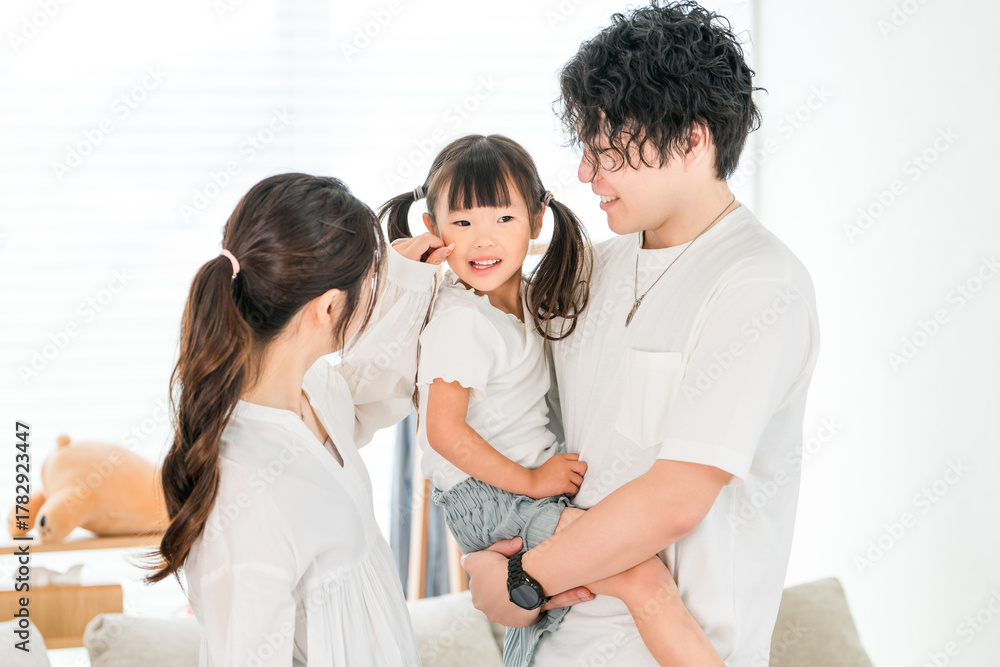 Fototapeta premium Young Asian couple holding their daughter at home, family, parent and child, family 