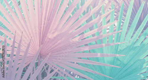 Tropical pastel palm leaves forming abstract pattern background