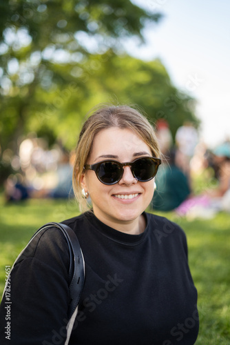 Portrait of young, beautiful, smiling woman in a city park in Berlin