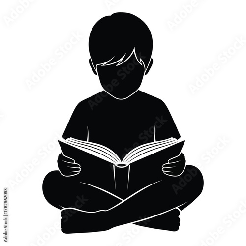 Silhouette of a boy reading a book in a cross legged position