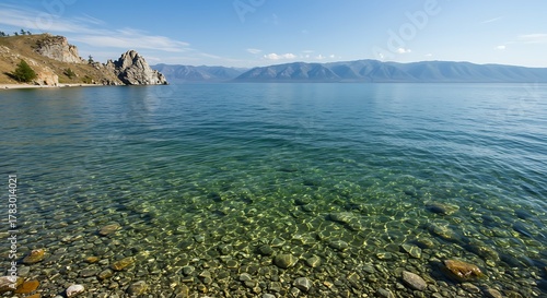 Crystal Clear Waters of Lake Baikal with Rocky Shoreline and Distant Mountains.