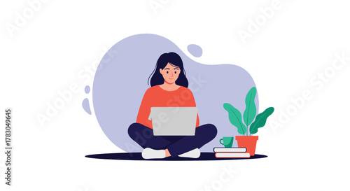A young woman sits cross-legged on the floor, focused on her laptop, with a plant and books beside her, embodying remote work and comfortable productivity.