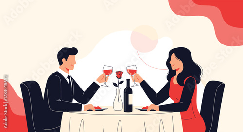 A happy couple enjoys a romantic dinner date, toasting with red wine glasses at a restaurant table adorned with a rose and a wine bottle.