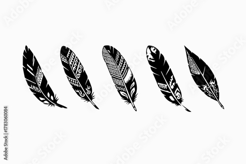 Collection of five ornate tribal patterned feathers in black silhouette isolated on white background