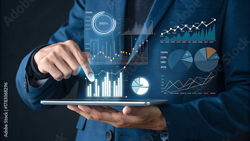 Businessman analyzing financial data with digital tablet and virtual interface
