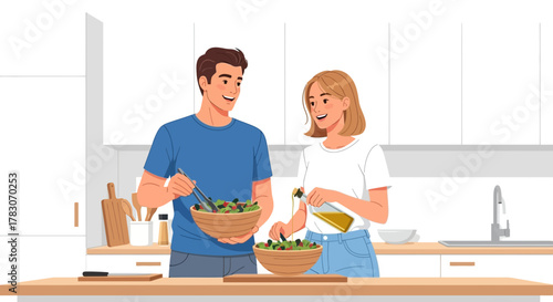 Joyful couple preparing a healthy fresh salad together in a bright modern kitchen, sharing a happy moment of culinary creation.