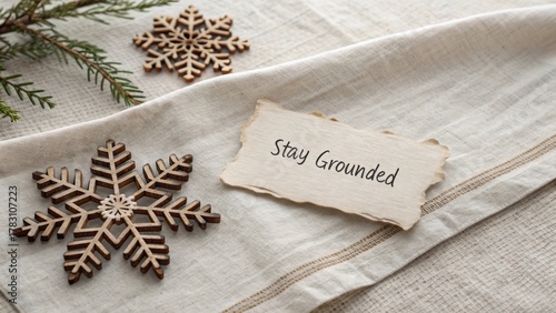 Wooden snowflakes on linen with a stay grounded message