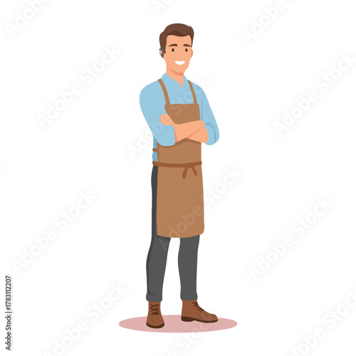 A friendly young man wearing a brown apron standing confidently with his arms crossed.