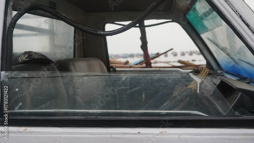 capture pick up car waiting for fish basket for sending on tradisional market soon on indonesia with blurry background tradisional fishman ship dan beach.
