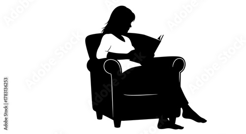 Enjoying an afternoon read as she relaxes in her armchair, she's captivated by the story, losing herself in the narrative, a moment of pure bliss