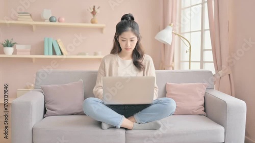 Serene Home Office: An individual works from home, immersed in concentration with a laptop on the couch, crafting the perfect scene of work-life balance.