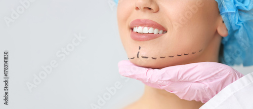 Plastic surgeon touching fa...
