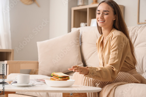 Beautiful young woman reach...