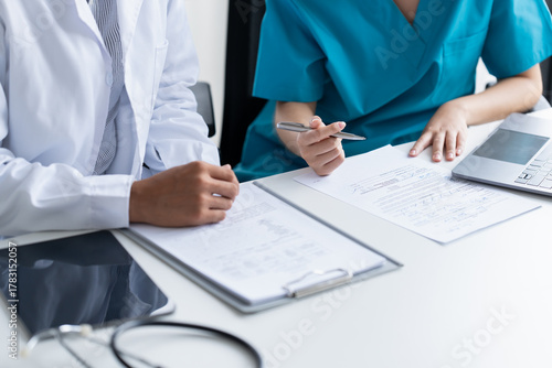 Fotografie Doctor and Medical Team Discussing Patient Care