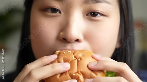 Woman eating burger closeup with fast food.