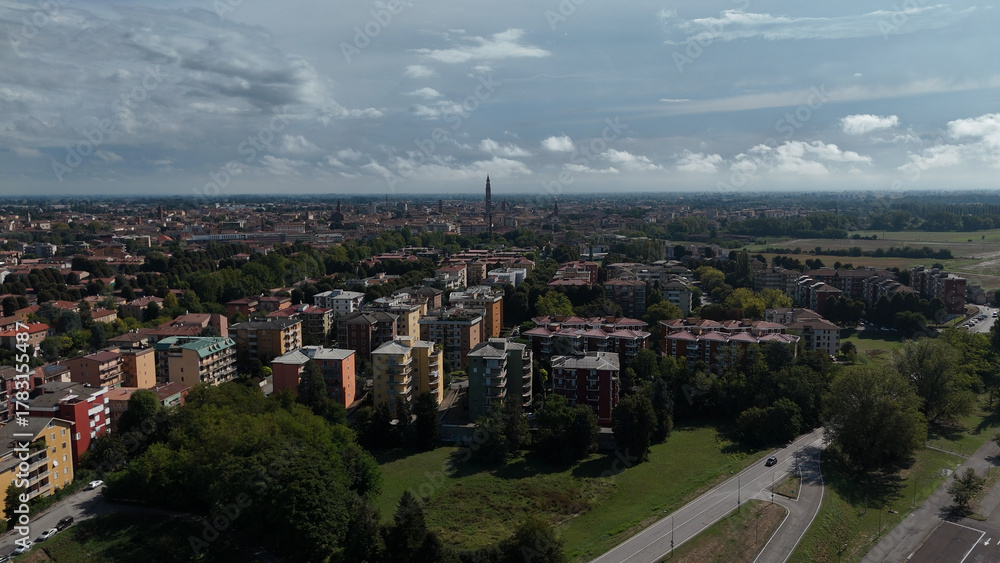 Fototapeta premium Panoramic Drone Aerial View of Cremona Cityscape Lombardy Italy Capturing Diverse Architecture and Green Spaces Under a Partly Cloudy Sky