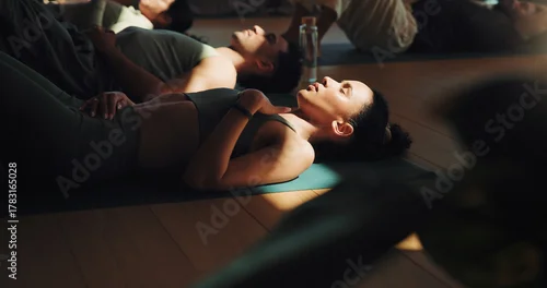 Fototapeta na wymiar Fitness, meditation and yoga with woman on floor in class for stress relief or wellness session. Breathing, exercise and shade with yogi people in studio for awareness, balance or mindfulness routine