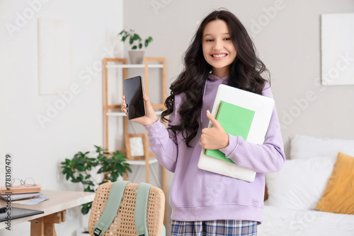 Teenage girl with laptop an...