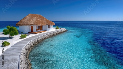 Fototapeta Naklejka Na Ścianę i Meble -  Luxury Overwater Bungalow Resort Overlooking Turquoise Ocean Waters Under a Clear Blue Sky on a Sunny Day with Lush Greenery and White Sand Beach